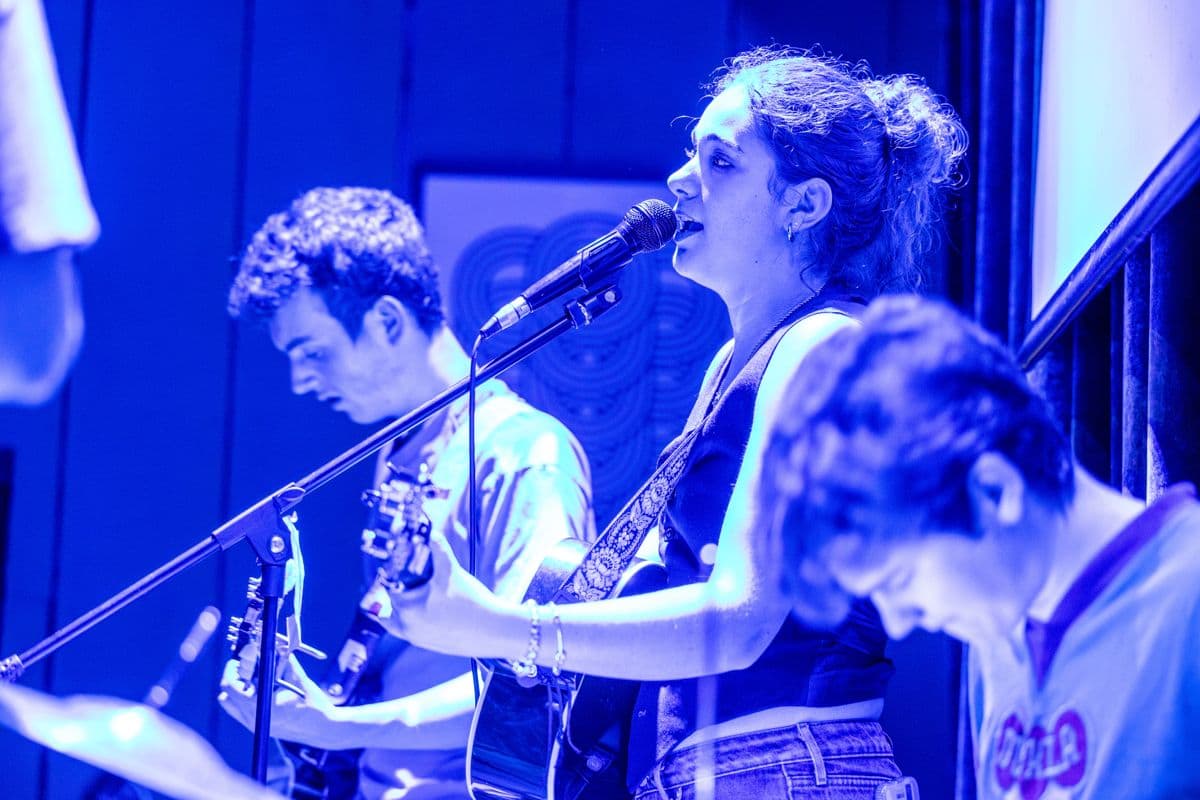 A singer and guitarists playing a live set
